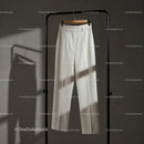 Classic White Trousers Hanging on Minimalist Rack