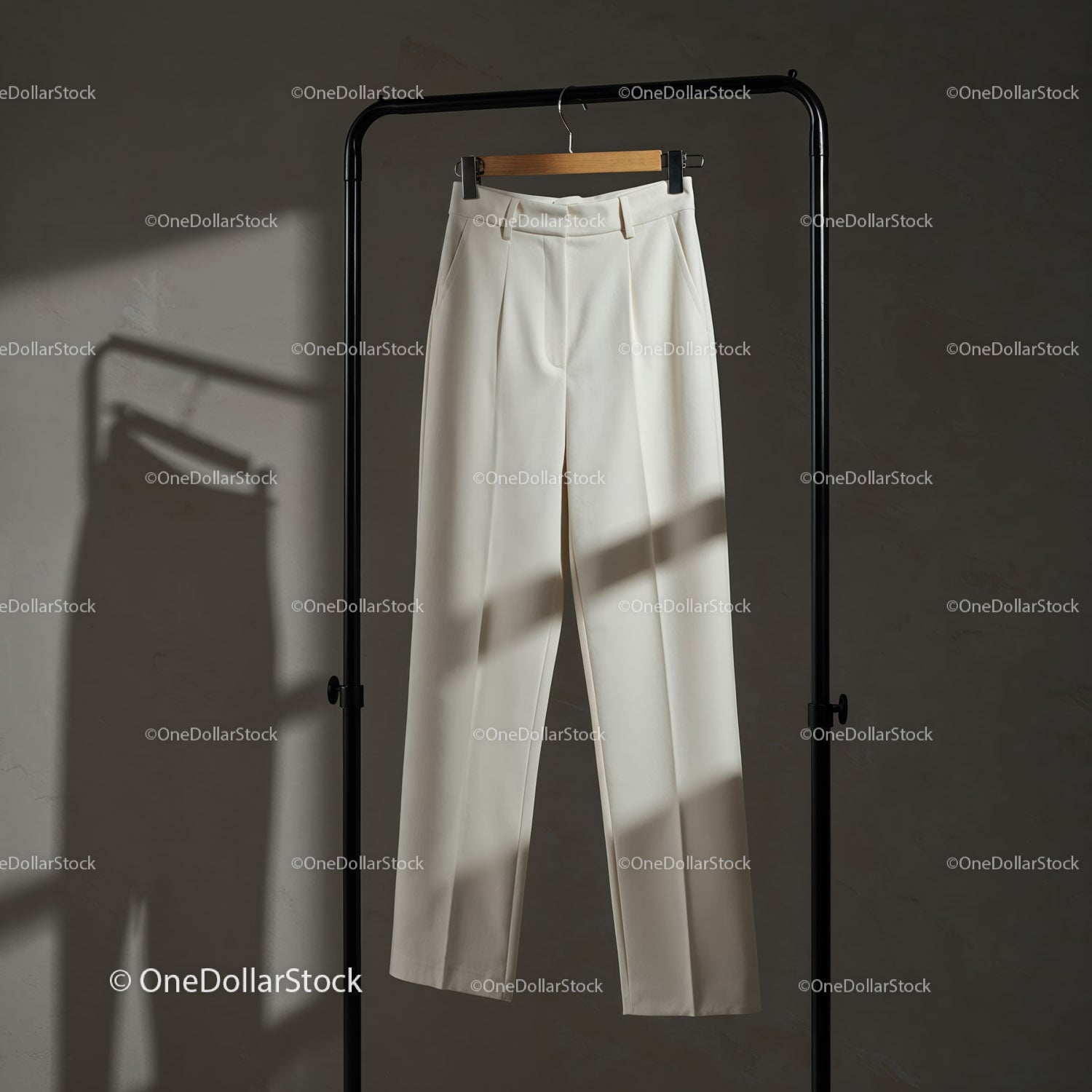 Classic White Trousers Hanging on Minimalist Rack
