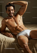 Smiling man relaxing on bed in white underwear
