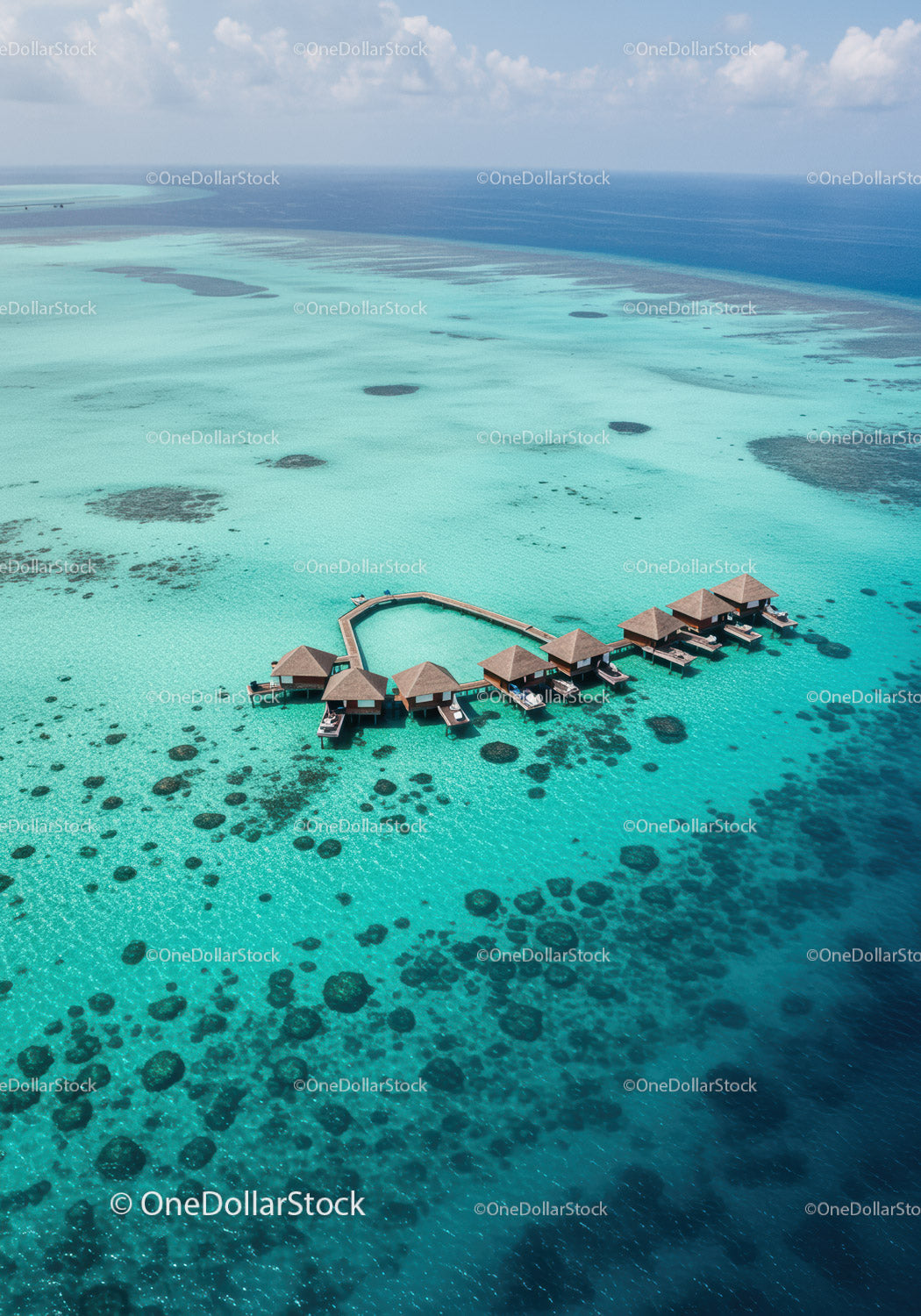 Tropical Overwater Bungalows Surrounded by Crystal Clear Turquoise Water
