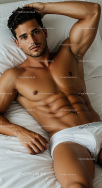 Fit man relaxing on bed in white underwear