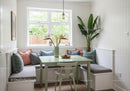 Bright Cozy Kitchen Nook with Indoor Plants and Pastel Green Table
