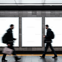 Blurred commuters walking past blank urban advertisements