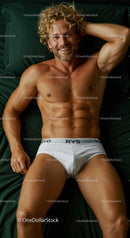Smiling muscular man relaxing on dark green bed sheets