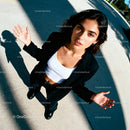Confident young woman standing outdoors with open hands