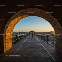 Sunset View from Historic Brick Arches Overlooking City Skyline