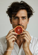 Male Model Holding Blood Orange Slice for Fresh and Healthy Lifestyle