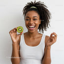 Young Woman Holding Kiwi Fruit with Bright Smile