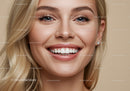 Closeup of smiling young woman with clear skin and blue eyes