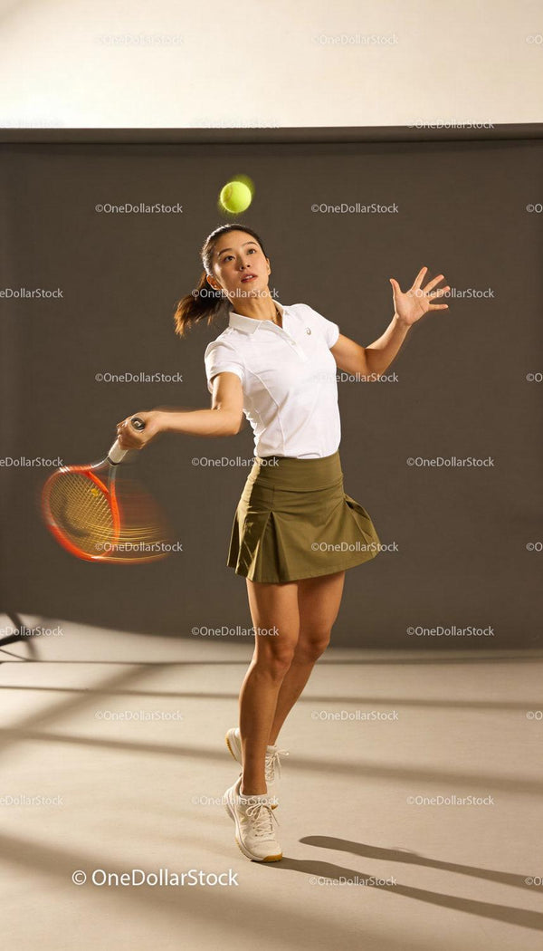 Focused female tennis player preparing to serve ball