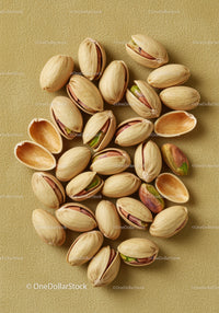 Close up of pistachio nuts with shells on textured surface