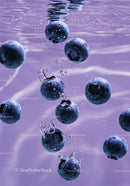 Fresh blueberries immersed in clear water with bubbles