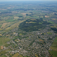 Vibrant Urban and Green Hills Landscape with Forested Mountains