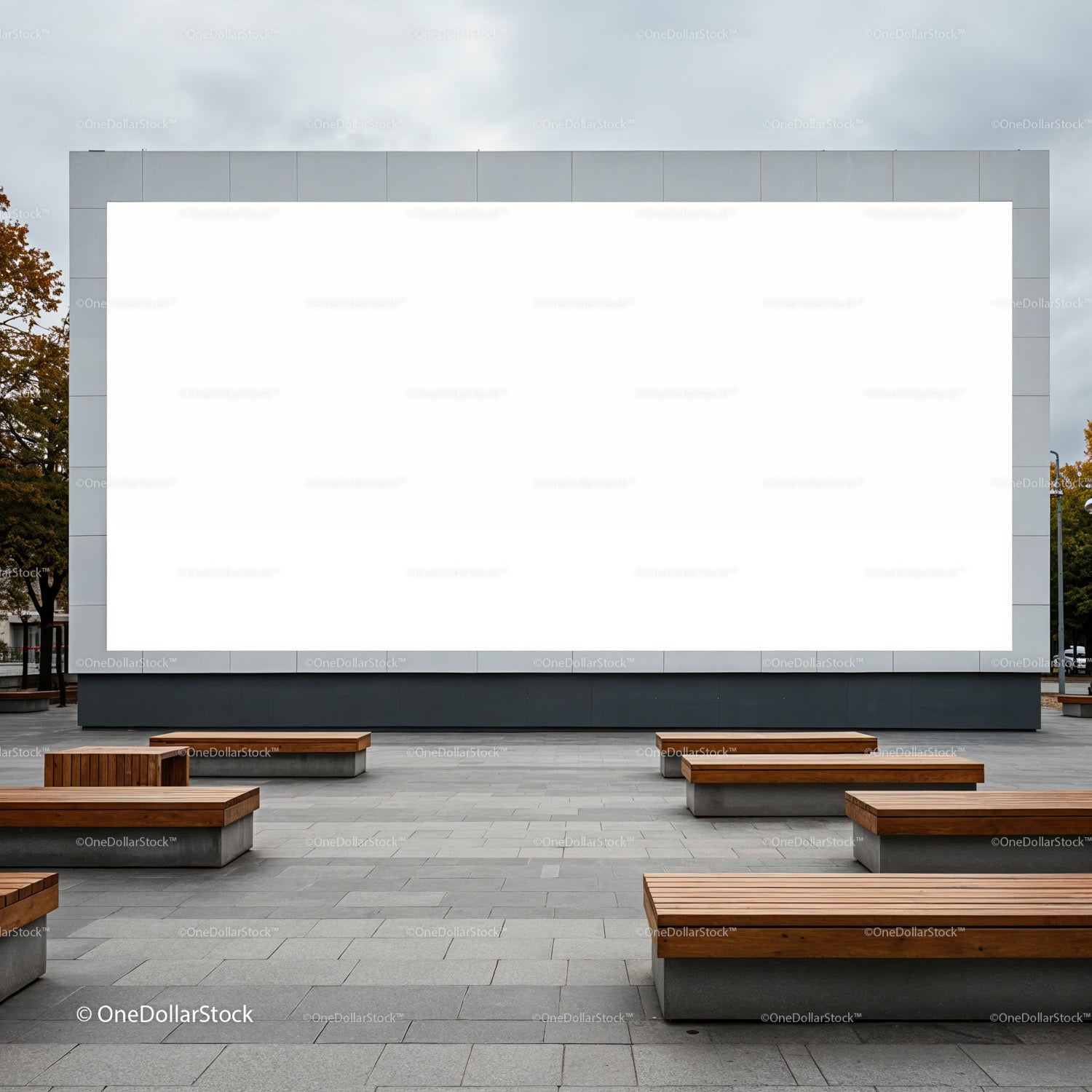 Outdoor urban space with large blank billboard and wooden benches