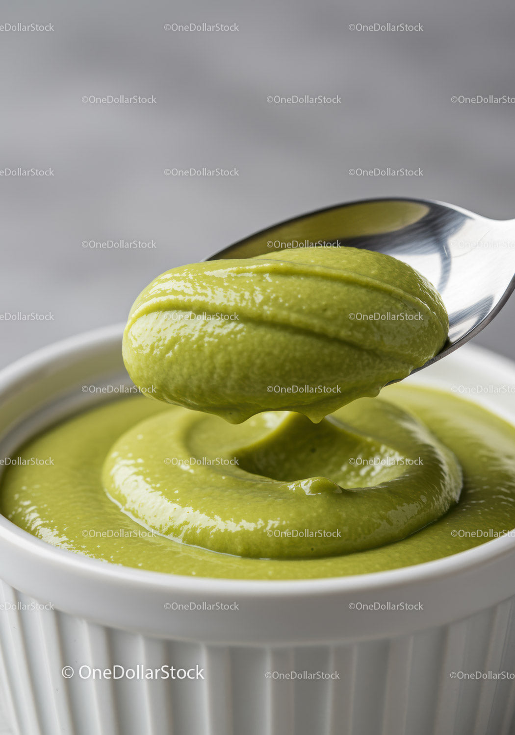 Creamy green avocado sauce served in white ramekin