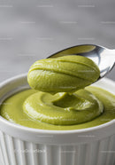 Creamy green avocado sauce served in white ramekin