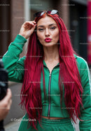 Vibrant Red Hair Woman in Green Tracksuit with Sunglasses in City