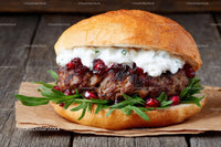 Gourmet Beef Burger with Cheese and Pomegranate on Rustic Wood