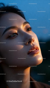 Young woman reflecting with soft warm light on face