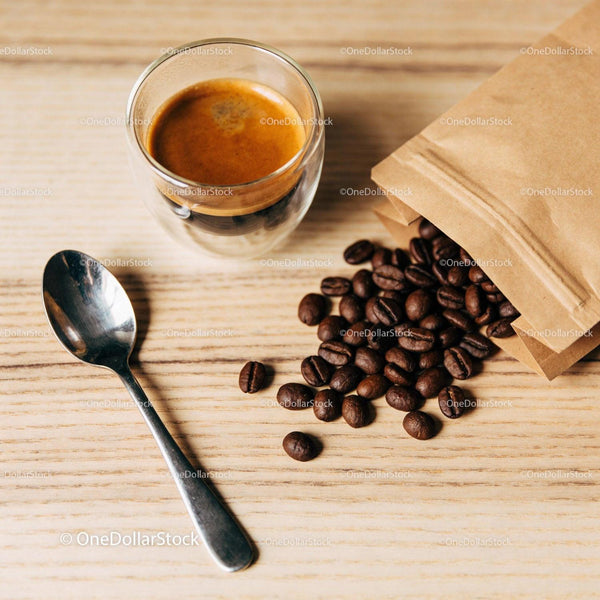 Freshly brewed espresso with scattered coffee beans