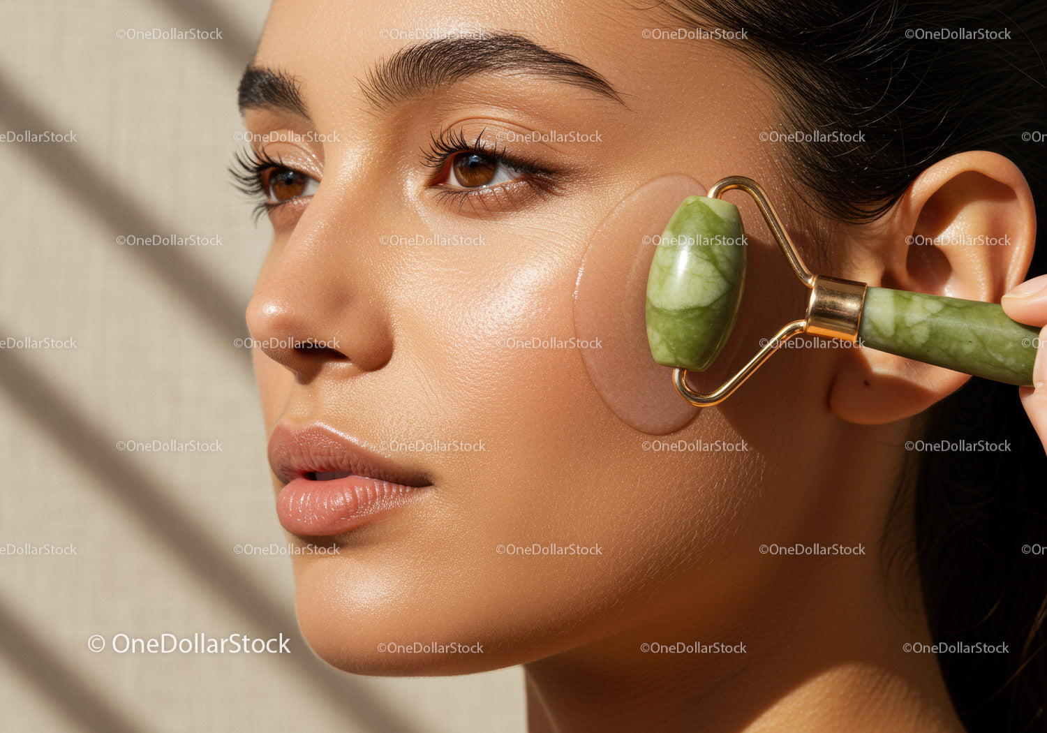 Close-up of Woman Using Jade Roller for Facial Skincare Wellness
