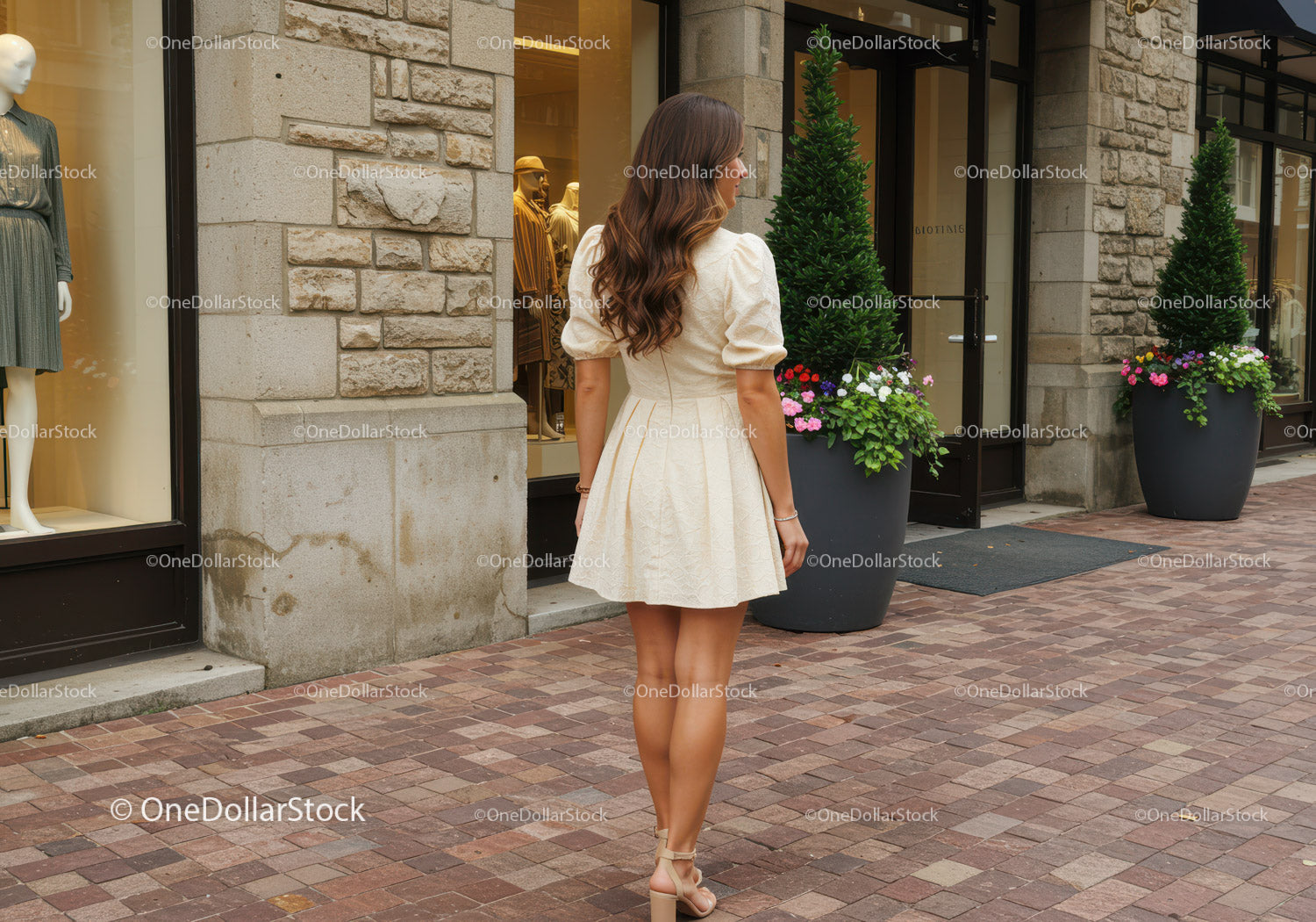 Fashionable Woman in Beige Dress Walking Past Storefront with Flower Pots
