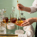 Elegant Amber Cocktail Being Poured in Stylish Bar Setting