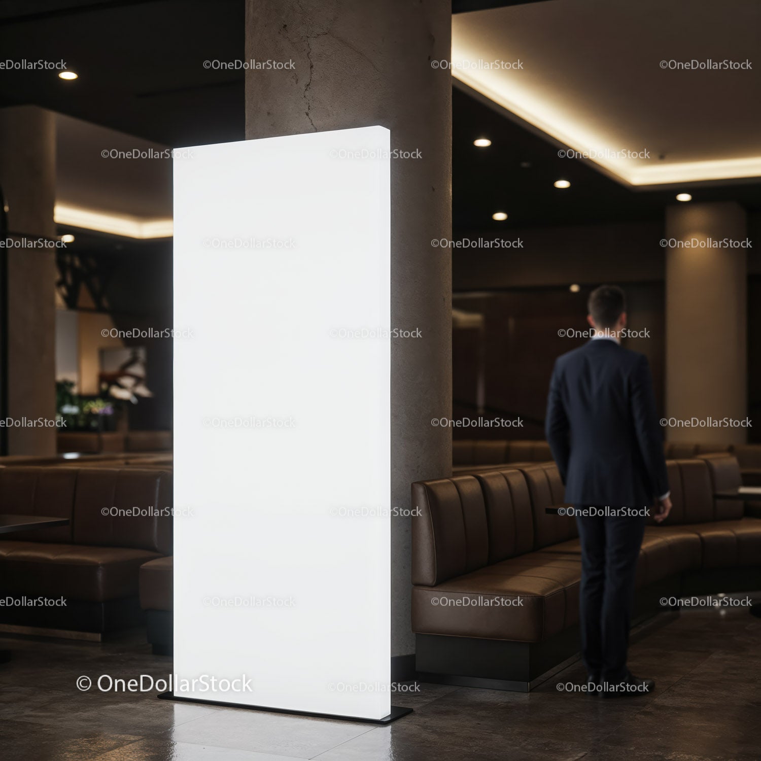 Businessman walking in modern lobby with light panel