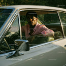 Young Man in Pink Shirt Sitting in Vintage Car on a Sunny Day