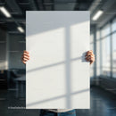 Person Holding Blank White Poster in Modern Office Space