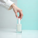 Beautiful woman applying white nail polish with a modern background