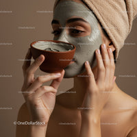 Woman Applying Clay Facial Mask with Bowl in Relaxing Spa Setting