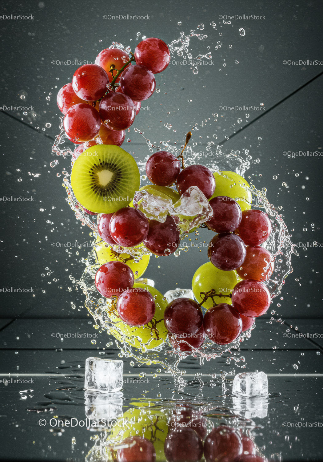 Fresh red and green grapes with kiwi and ice splash