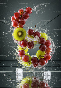 Fresh red and green grapes with kiwi and ice splash