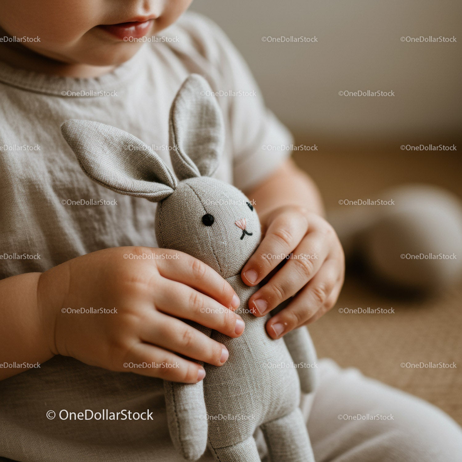 Toddler Holding Soft Gray Fabric Bunny Toy