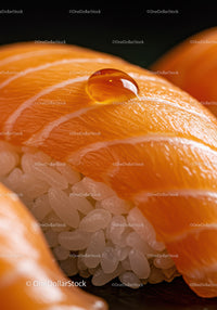 Close up of fresh salmon sushi with rice and water droplet