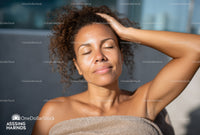 Relaxing Woman with Curly Hair Enjoying Sunlight Outdoors