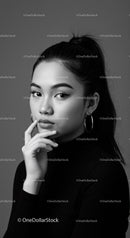 Elegant Black and White Portrait of Young Woman with Hoop Earrings