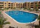 Scenic Resort Swimming Pool with Lounge Chairs and Palm Trees