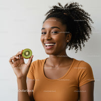 Joyful Woman Holding Kiwi Fruit in Bright Studio Setting