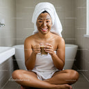 Happy Woman with Face Mask Sitting in Bathroom Holding Coffee Cup
