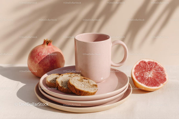Fresh Pomegranate and Grapefruit with Pink Mug and Plates