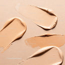 Various shades of liquid foundation textures on beige background