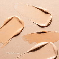 Various shades of liquid foundation textures on beige background