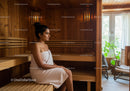Woman Relaxing in Wooden Sauna Room with Natural Light