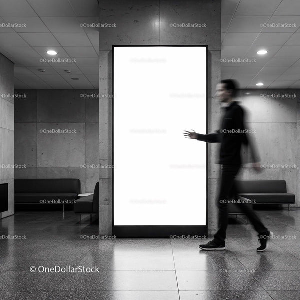 Blurred man walking past illuminated blank billboard indoors JPG Mockup Image