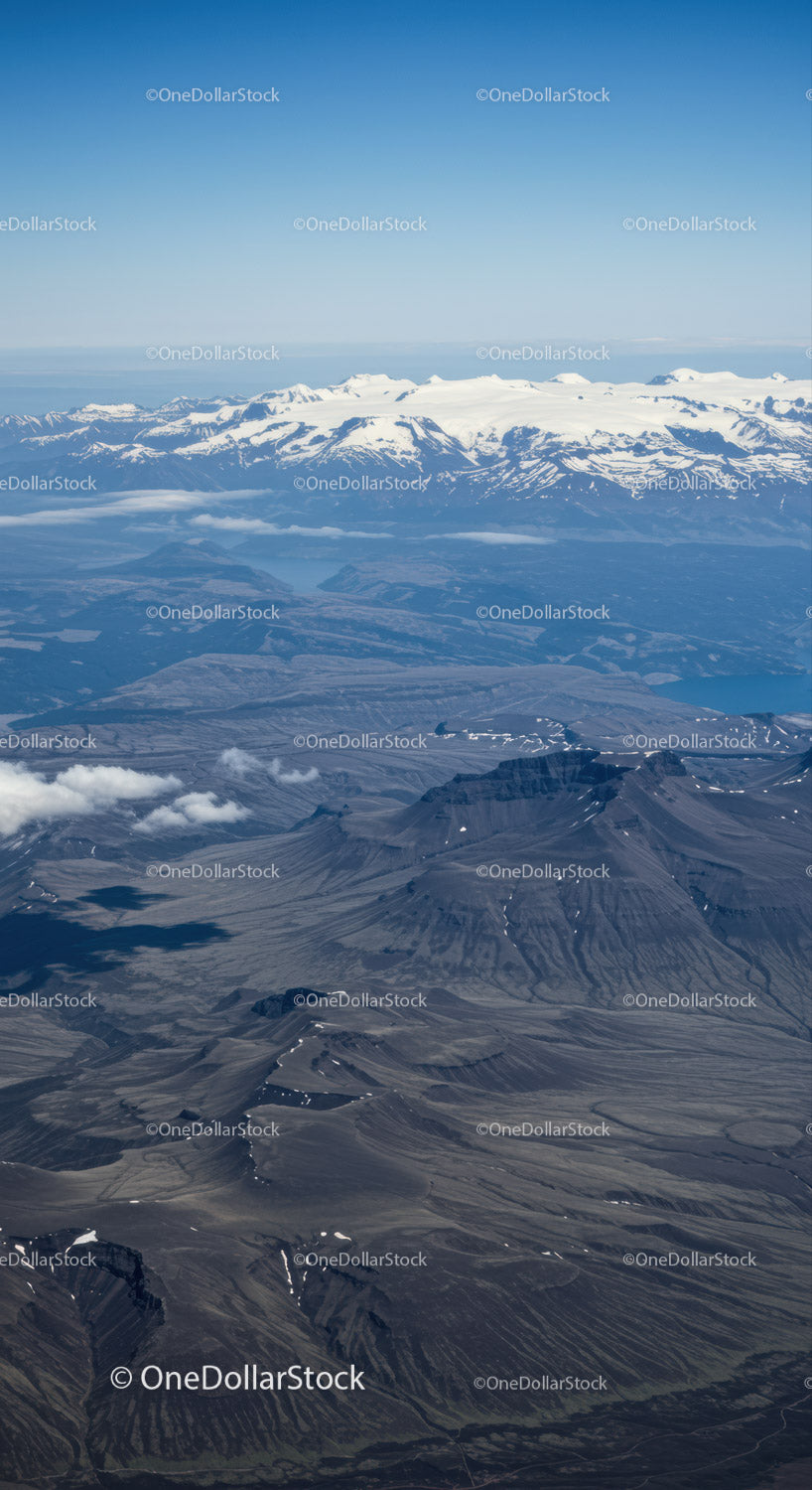Majestic Snow-Capped Mountains and Rugged Volcanoes in Aerial Panorama