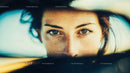 Close-Up of a Woman with Blue Eyes and Freckles in Sunlight