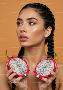 Elegant Woman Holding Half of Exotic Pink Dragon Fruit for Beauty and Wellness