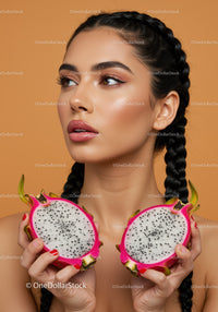 Elegant Woman Holding Half of Exotic Pink Dragon Fruit for Beauty and Wellness